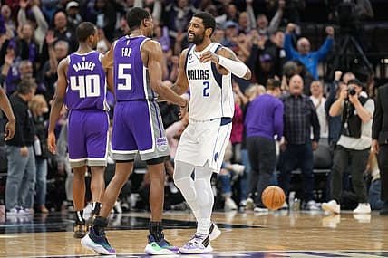 Feb 11, 2023; Sacramento, California, USA; Sacramento Kings guard De'Aaron Fox (5) and Dallas Mavericks guard Kyrie Irving (2) greet each other after the game at Golden 1 Center. Mandatory Credit: Darren Yamashita-USA TODAY Sports