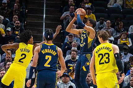 Feb 13, 2023; Indianapolis, Indiana, USA; Indiana Pacers guard Tyrese Haliburton (0) shoots the ball while Utah Jazz guard Collin Sexton (2) defends in the first quarter at Gainbridge Fieldhouse. Mandatory Credit: Trevor Ruszkowski-USA TODAY Sports
