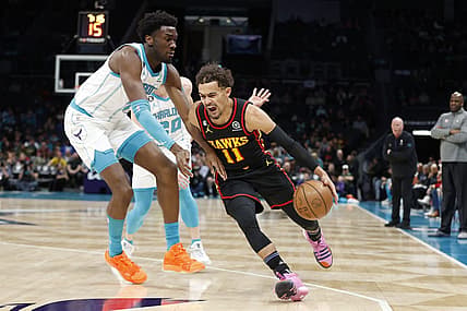Feb 13, 2023; Charlotte, North Carolina, USA; Atlanta Hawks guard Trae Young (11) drives past Charlotte Hornets center Mark Williams (5) during the first quarter at Spectrum Center. Mandatory Credit: Brian Westerholt-USA TODAY Sports