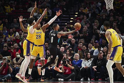 Feb 13, 2023; Portland, Oregon, USA; Portland Trail Blazers guard Damian Lillard (0) drives to the basket during the first half against Los Angeles Lakers forward Anthony Davis (3) and forward Rui Hachimura (28) at Moda Center. Mandatory Credit: Troy Wayrynen-USA TODAY Sports