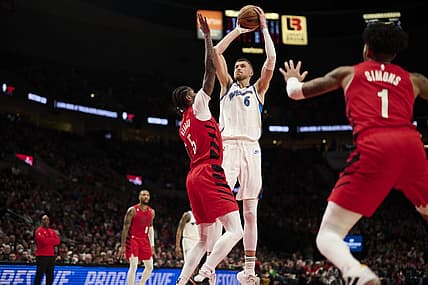 Feb 14, 2023; Portland, Oregon, USA; Washington Wizards center Kristaps Porzingis (6) shoots a jump shot during the first half against Portland Trail Blazers forward Cam Reddish (5) at Moda Center. Mandatory Credit: Troy Wayrynen-USA TODAY Sports
