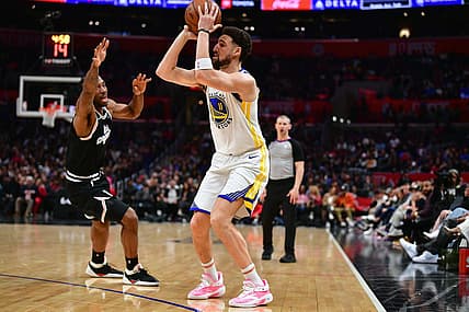 Feb 14, 2023; Los Angeles, California, USA; Golden State Warriors guard Klay Thompson (11) shoots against Los Angeles Clippers forward Kawhi Leonard (2) during the second half at Crypto.com Arena. Mandatory Credit: Gary A. Vasquez-USA TODAY Sports