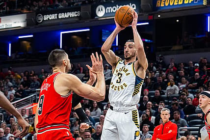 Feb 15, 2023; Indianapolis, Indiana, USA; Indiana Pacers guard Chris Duarte (3) passes the ball while Chicago Bulls center Nikola Vucevic (9) defends in the second quarter at Gainbridge Fieldhouse. Mandatory Credit: Trevor Ruszkowski-USA TODAY Sports