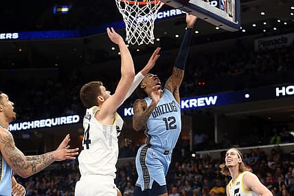 Feb 15, 2023; Memphis, Tennessee, USA; Memphis Grizzlies guard Ja Morant (12) shoots as Utah Jazz center Walker Kessler (24) defends during the first half at FedExForum. Mandatory Credit: Petre Thomas-USA TODAY Sports