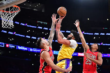 Feb 15, 2023; Los Angeles, California, USA; Los Angeles Lakers forward Anthony Davis (3) moves to the basket against New Orleans Pelicans center Willy Hernangomez (9) and guard Trey Murphy III (25) during the first half at Crypto.com Arena. Mandatory Credit: Gary A. Vasquez-USA TODAY Sports