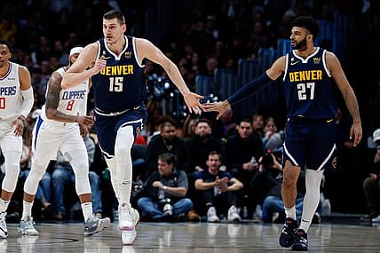 Feb 26, 2023; Denver, Colorado, USA; Denver Nuggets center Nikola Jokic (15) reacts with guard Jamal Murray (27) after a play in the first quarter against the Los Angeles Clippers at Ball Arena. Mandatory Credit: Isaiah J. Downing-USA TODAY Sports