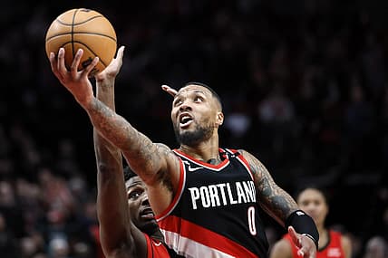 Feb 26, 2023; Portland, Oregon, USA; Portland Trail Blazers point guard Damian Lillard (0) shoots the ball past Houston Rockets small forward Jae'Sean Tate (8, left) during the second half at Moda Center. Mandatory Credit: Soobum Im-USA TODAY Sports