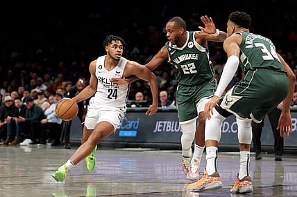 Feb 28, 2023; Brooklyn, New York, USA; Brooklyn Nets guard Cam Thomas (24) controls the ball against Milwaukee Bucks forward Khris Middleton (22) and forward Giannis Antetokounmpo (34) during the first quarter at Barclays Center. Mandatory Credit: Brad Penner-USA TODAY Sports