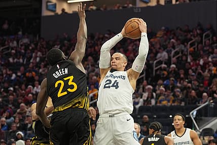 Dec 25, 2022; San Francisco, California, USA; Memphis Grizzlies forward Dillon Brooks (24) handles the ball against Golden State Warriors forward Draymond Green (23) during the fourth quarter at Chase Center. Mandatory Credit: Darren Yamashita-USA TODAY Sports