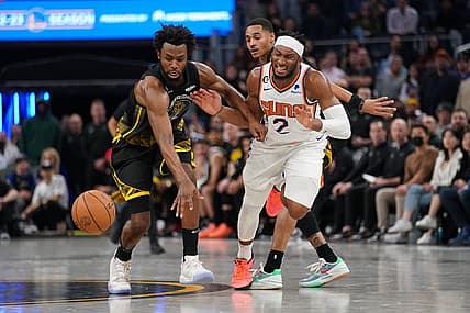 Jan 10, 2023; San Francisco, California, USA; Golden State Warriors forward Andrew Wiggins (22) knocks the ball out of the hands of Phoenix Suns guard Josh Okogie (2) in the fourth quarter at the Chase Center. Mandatory Credit: Cary Edmondson-USA TODAY Sports