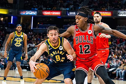 Jan 24, 2023; Indianapolis, Indiana, USA; Indiana Pacers guard T.J. McConnell (9) dribbles the ball while Chicago Bulls guard Ayo Dosunmu (12) defends in the second quarter at Gainbridge Fieldhouse. Mandatory Credit: Trevor Ruszkowski-USA TODAY Sports