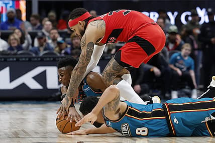 Feb 25, 2023; Detroit, Michigan, USA;Detroit Pistons guard Hamidou Diallo (6) guard Jared Rhoden (8) and Toronto Raptors guard Gary Trent Jr. (33) go after the ball in the second half at Little Caesars Arena. Mandatory Credit: Rick Osentoski-USA TODAY Sports