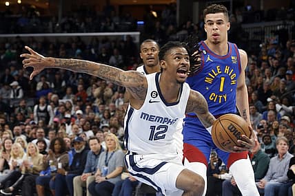 Feb 25, 2023; Memphis, Tennessee, USA; Memphis Grizzlies guard Ja Morant (12) drives to the basket as Denver Nuggets forward Michael Porter Jr. (1) defends during the second half at FedExForum. Mandatory Credit: Petre Thomas-USA TODAY Sports