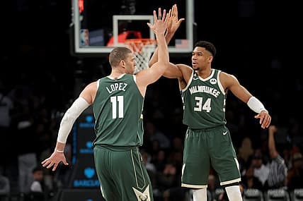 Feb 28, 2023; Brooklyn, New York, USA; Milwaukee Bucks center Brook Lopez (11) high fives forward Giannis Antetokounmpo (34) during the third quarter against the Brooklyn Nets at Barclays Center. Mandatory Credit: Brad Penner-USA TODAY Sports