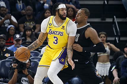 Feb 28, 2023; Memphis, Tennessee, USA; Los Angeles Lakers forward Anthony Davis (3) handles the ball as Memphis Grizzlies forward Xavier Tillman (2) defends during the first half at FedExForum. Mandatory Credit: Petre Thomas-USA TODAY Sports