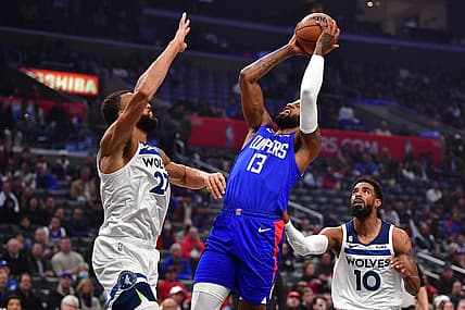 Feb 28, 2023; Los Angeles, California, USA; Los Angeles Clippers forward Paul George (13) shoots against Minnesota Timberwolves center Rudy Gobert (27) and guard Mike Conley (10) during the first half at Crypto.com Arena. Mandatory Credit: Gary A. Vasquez-USA TODAY Sports