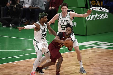 Mar 1, 2023; Boston, Massachusetts, USA;  Cleveland Cavaliers guard Darius Garland (10) controls the ball while Boston Celtics guard Marcus Smart (36) and forward Mike Mascala (57) defend during the first half at TD Garden. Mandatory Credit: Bob DeChiara-USA TODAY Sports