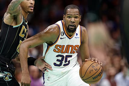 Mar 1, 2023; Charlotte, North Carolina, USA; Phoenix Suns forward Kevin Durant (35) drives to the basket past Charlotte Hornets guard Kelly Oubre Jr. (12) during the second half at Spectrum Center. Mandatory Credit: Brian Westerholt-USA TODAY Sports