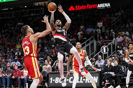 Mar 3, 2023; Atlanta, Georgia, USA; Portland Trail Blazers guard Damian Lillard (0) shoots over Atlanta Hawks guard Bogdan Bogdanovic (13) during the first half at State Farm Arena. Mandatory Credit: Dale Zanine-USA TODAY Sports
