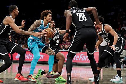 Mar 5, 2023; Brooklyn, New York, USA; Charlotte Hornets guard Kelly Oubre Jr. (12) drives to the basket against Brooklyn Nets center Nic Claxton (33) and guard Cam Thomas (24) and forward Dorian Finney-Smith (28) and guard Spencer Dinwiddie (26) during the second quarter at Barclays Center. Mandatory Credit: Brad Penner-USA TODAY Sports