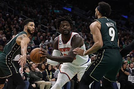 Mar 5, 2023; Boston, Massachusetts, USA; New York Knicks forward Julius Randle (30) looks for an opening between Boston Celtics guard Derrick White (9) and forward Jayson Tatum (0) during the first quarter at TD Garden. Mandatory Credit: Winslow Townson-USA TODAY Sports