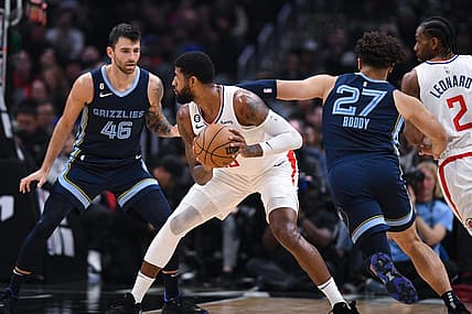 Mar 5, 2023; Los Angeles, California, USA; LA Clippers forward Paul George (13) looks to pass the ball against Memphis Grizzlies guard John Konchar (46) and forward David Roddy (27) during second quarter at Crypto.com Arena. Mandatory Credit: Jonathan Hui-USA TODAY Sports