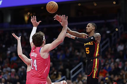 Mar 8, 2023; Washington, District of Columbia, USA; Atlanta Hawks guard Dejounte Murray (5) leaps to pass the ball over Washington Wizards forward Corey Kispert (24) in the first quarter at Capital One Arena. Mandatory Credit: Geoff Burke-USA TODAY Sports
