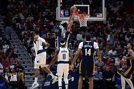 Mar 8, 2023; New Orleans, Louisiana, USA;  New Orleans Pelicans guard Trey Murphy III (25) dunks the ball against Dallas Mavericks forward Markieff Morris (13) during the first half at Smoothie King Center. Mandatory Credit: Stephen Lew-USA TODAY Sports