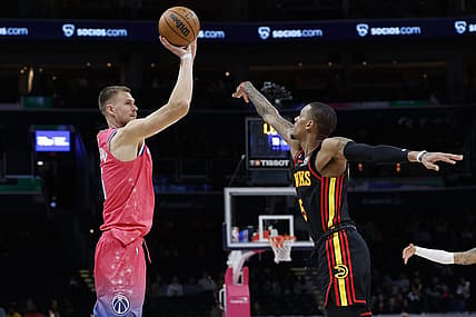 Mar 8, 2023; Washington, District of Columbia, USA; Washington Wizards center Kristaps Porzingis (6) shoots the ball as Atlanta Hawks guard Dejounte Murray (5) defends in the fourth quarter at Capital One Arena. Mandatory Credit: Geoff Burke-USA TODAY Sports