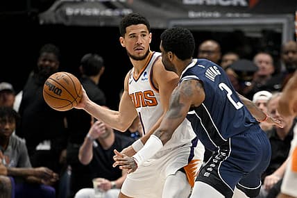 Mar 5, 2023; Dallas, Texas, USA; Phoenix Suns guard Devin Booker (1) and Dallas Mavericks guard Kyrie Irving (2) in action during the game between the Dallas Mavericks and the Phoenix Suns at the American Airlines Center. Mandatory Credit: Jerome Miron-USA TODAY Sports