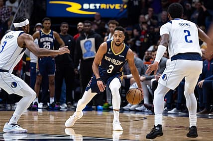 Mar 8, 2023; New Orleans, Louisiana, USA;  New Orleans Pelicans guard CJ McCollum (3) brings the ball up court against Dallas Mavericks guard Kyrie Irving (2) and guard Jaden Hardy (3) during the second half at Smoothie King Center. Mandatory Credit: Stephen Lew-USA TODAY Sports