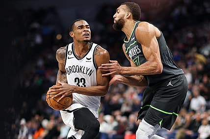 Mar 10, 2023; Minneapolis, Minnesota, USA; Brooklyn Nets center Nic Claxton (33) drives while Minnesota Timberwolves center Rudy Gobert (27) defends during the second quarter at Target Center. Mandatory Credit: Matt Krohn-USA TODAY Sports