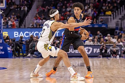 Mar 13, 2023; Detroit, Michigan, USA; Detroit Pistons guard Killian Hayes (7) controls the ball in front of Indiana Pacers guard Andrew Nembhard (2) during the first quarter at Little Caesars Arena. Mandatory Credit: David Reginek-USA TODAY Sports
