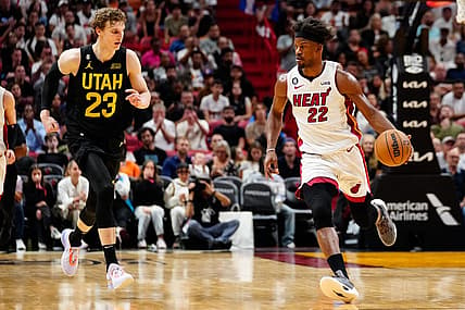 Mar 13, 2023; Miami, Florida, USA; Miami Heat forward Jimmy Butler (22) dribbles the ball past Utah Jazz forward Lauri Markkanen (23) during the fourth quarter at Miami-Dade Arena. Mandatory Credit: Rich Storry-USA TODAY Sports