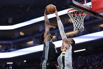 Mar 13, 2023; Sacramento, California, USA; Milwaukee Bucks center Brook Lopez (11) blocks the shot of Sacramento Kings power forward Chimezie Metu (7) during the first quarter at Golden 1 Center. Mandatory Credit: Kelley L Cox-USA TODAY Sports