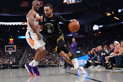 Mar 13, 2023; San Francisco, California, USA; Golden State Warriors guard Stephen Curry (30) dribbles the ball next to Phoenix Suns guard Chris Paul (3) in the second quarter at the Chase Center. Mandatory Credit: Cary Edmondson-USA TODAY Sports