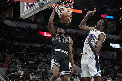 Mar 14, 2023; San Antonio, Texas, USA;  San Antonio Spurs guard Blake Wesley (14) dunks against Orlando Magic center Bol Bol (10) in the first half at the AT&T Center. Mandatory Credit: Daniel Dunn-USA TODAY Sports