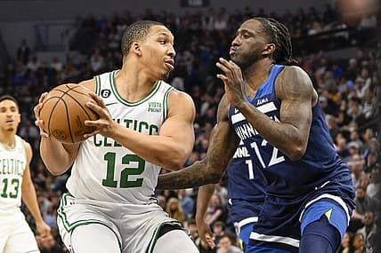 Mar 15, 2023; Minneapolis, Minnesota, USA;  Boston Celtics forward Grant Williams (12) protects the ball from Minnesota Timberwolves forward Taurean Prince (12) in the first quarter at Target Center. Mandatory Credit: Nick Wosika-USA TODAY Sports