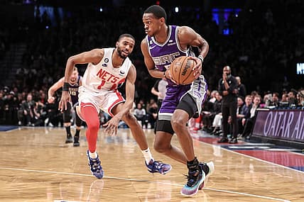 Mar 16, 2023; Brooklyn, New York, USA;  Sacramento Kings guard De'Aaron Fox (5) looks to drive past Brooklyn Nets forward Mikal Bridges (1) in the second quarter at Barclays Center. Mandatory Credit: Wendell Cruz-USA TODAY Sports
