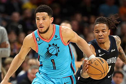 Mar 16, 2023; Phoenix, Arizona, USA; Orlando Magic guard Markelle Fultz (right) steals the ball from Phoenix Suns guard Devin Booker in the first half at Footprint Center. Mandatory Credit: Mark J. Rebilas-USA TODAY Sports