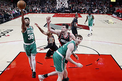 Mar 17, 2023; Portland, Oregon, USA; Boston Celtics point guard Marcus Smart (36) shoots the ball against Portland Trail Blazers shooting guard Anfernee Simons (1, center) and power forward Drew Eubanks (24) uring the first half at Moda Center. Mandatory Credit: Soobum Im-USA TODAY Sports