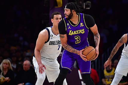Mar 17, 2023; Los Angeles, California, USA; Los Angeles Lakers forward Anthony Davis (3) controls the ball against Dallas Mavericks center Dwight Powell (7) during the first half at Crypto.com Arena. Mandatory Credit: Gary A. Vasquez-USA TODAY Sports