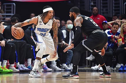 Mar 18, 2023; Los Angeles, California, USA; Orlando Magic guard Markelle Fultz (20) controls the ball against Los Angeles Clippers forward Marcus Morris Sr. (8) during the first half at Crypto.com Arena. Mandatory Credit: Gary A. Vasquez-USA TODAY Sports
