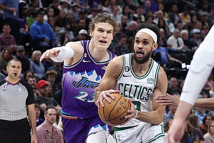 Mar 18, 2023; Salt Lake City, Utah, USA; Boston Celtics guard Derrick White (9) drives on Utah Jazz forward Lauri Markkanen (23) in the first quarter at Vivint Arena. Mandatory Credit: Rob Gray-USA TODAY Sports