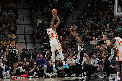 Mar 19, 2023; San Antonio, Texas, USA; Atlanta Hawks forward De'Andre Hunter (12) shoots over San Antonio Spurs guard Malaki Branham (22) in the first half at the AT&T Center. Mandatory Credit: Daniel Dunn-USA TODAY Sports