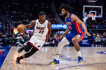 Mar 19, 2023; Detroit, Michigan, USA; Miami Heat forward Jimmy Butler (22) drives to the basket against Detroit Pistons forward Marvin Bagley III (35) in the first quarter at Little Caesars Arena. Mandatory Credit: Allison Farrand-USA TODAY Sports