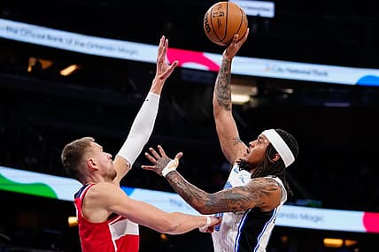 Mar 21, 2023; Orlando, Florida, USA; Orlando Magic guard Markelle Fultz (20) shoots over Washington Wizards center Kristaps Porzingis (6) during the first quarter at Amway Center. Mandatory Credit: Rich Storry-USA TODAY Sports