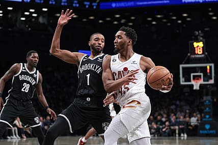 Mar 21, 2023; Brooklyn, New York, USA; Cleveland Cavaliers guard Donovan Mitchell (45) dribbles against Brooklyn Nets forward Mikal Bridges (1) during the first quarter at Barclays Center. Mandatory Credit: Vincent Carchietta-USA TODAY Sports