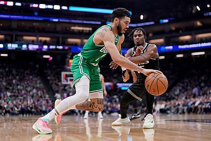 Mar 21, 2023; Sacramento, California, USA; Boston Celtics forward Jayson Tatum (0) dribbles past Sacramento Kings guard Davion Mitchell (15) in the second quarter at the Golden 1 Center. Mandatory Credit: Cary Edmondson-USA TODAY Sports