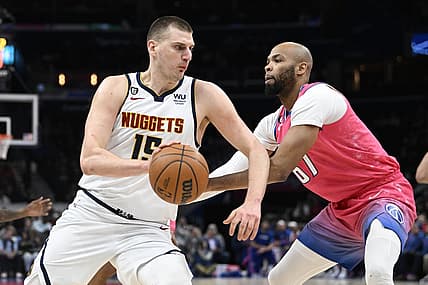Mar 22, 2023; Washington, District of Columbia, USA; Denver Nuggets center Nikola Jokic (15) dribbles as Washington Wizards forward Taj Gibson (67) defends during the first half at Capital One Arena. Mandatory Credit: Brad Mills-USA TODAY Sports